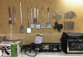 MANY NEW AND UNUSED CAMPING AND OUTDOOR GRILLING ACCESSORIES.