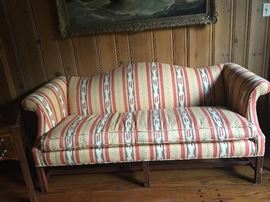 Vintage camelback sofa with carved square legs