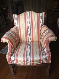 Vintage camelback chair with carved square legs