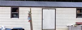 12x30 Americana Steel frame shed w/roll-up side door and regular door, 4 windows, vents. Wired w/4 20 amp breakers.


