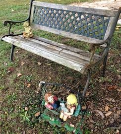 Outdoor bench, two of the yard art statues