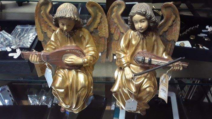 This pair of seated hand carved angels will be sold separately or by the pair.