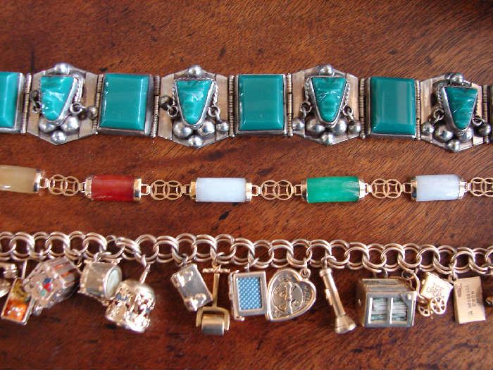 Silver charm bracelet. 14k similar one not shown. Jade bracelet, one of two. Not shown a multi color jade coordinating necklace.
