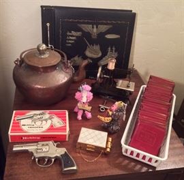 More vintage goodies: Japanese copper teapot, Hubley Trooper toy cap gun with box, Zell compact/coin purse combo, funny yarn animals, German toy sewing machine, military theme scrapbook (empty), Little Leather Library books (red cover)