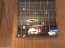 Glass covered shadow box with thimbles