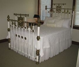 Iron and brass bed with mother of pearl medallions.