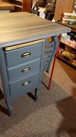 Upcycled kitchen island. Made from half of an old desk, corbels and pipe legs for added stability.