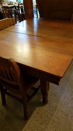 Antique farm table with 5 leaves. 150+ years old. Set of four very sturdy school chairs.