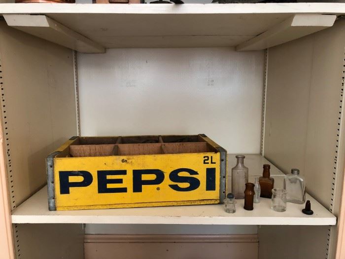 Vintage Pepsi crate and bottles. Located upstairs bedroom on right.