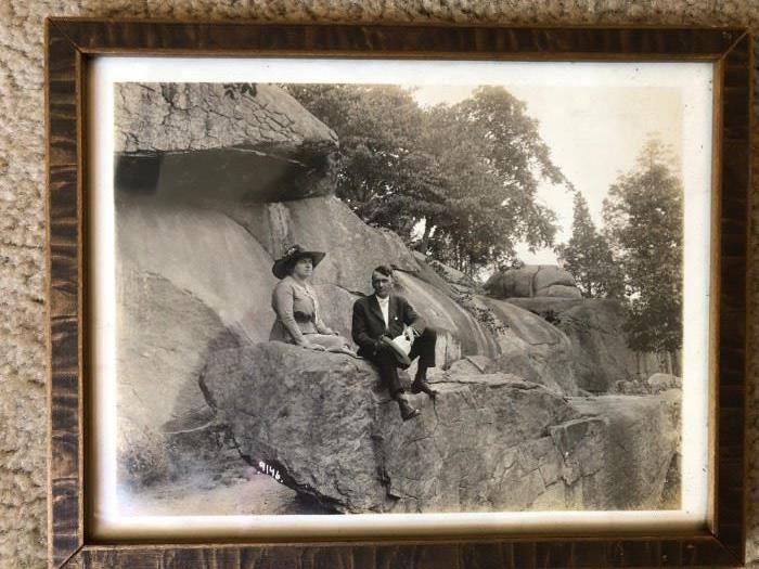 Fabulous photograph of a man and woman sitting on rocks. Early 1900's. Located upstairs, bedroom on right.
