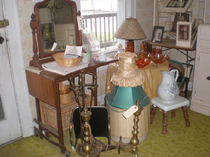 Standing mirror, typewriter table, fireplace tools sold and adirons, lamps shades, pitcher, stool.