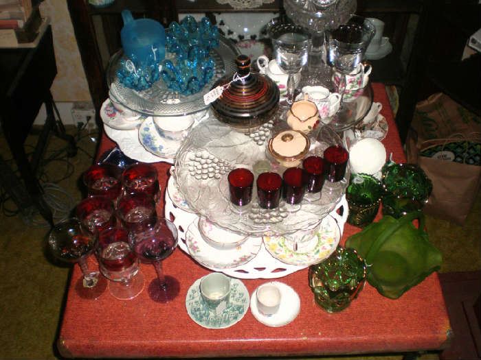 Pedestal cake plates, kings crown ruby flashed goblets, green and glue glass, teacups and saucers.