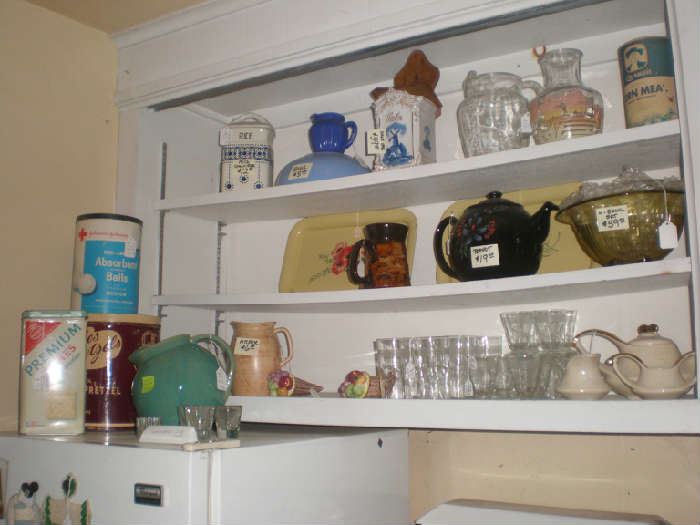 Depression glass yellow bowl set, glassware, teapots, juice pitcher, wter pitcher, salt box, other tins.