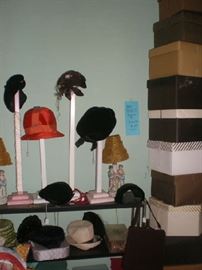 Display pieces for hats, and hats, lots of hat boxes with advertising on them. 