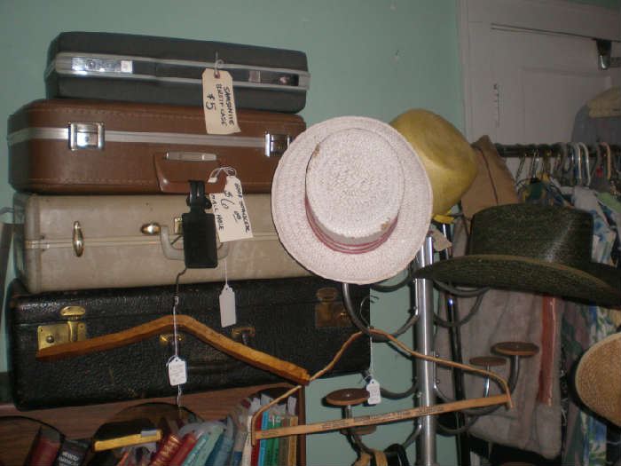Suitcases, men's hats, advertising hangers.