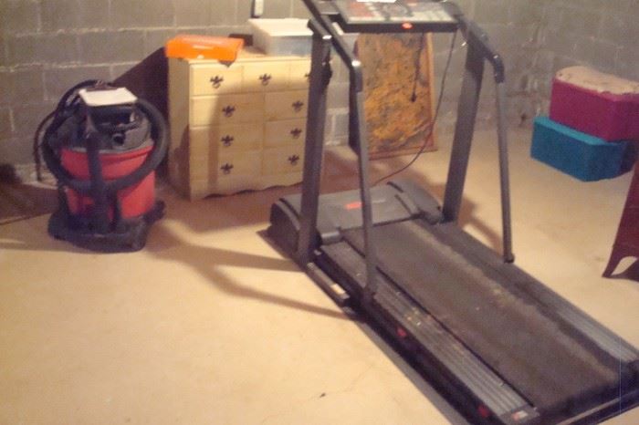 Proform tradmill, shop vac and white chest.