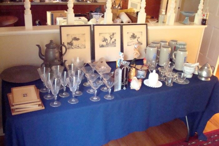 Table of collectibles including early pewter items.