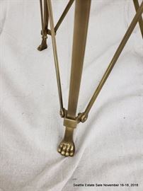 Bronze and glass side table with lion's paw feet.