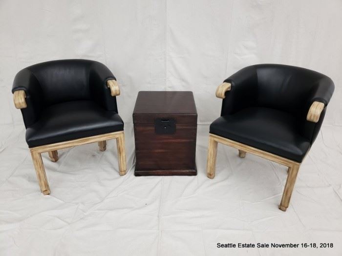 Barrel back club chair with black upholstery and carved arms.
Mahogany-stained lift-top storage box.