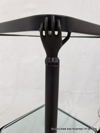 Patinated bronze and glass side table with hand and feet details.