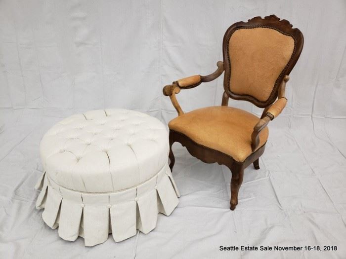 Shield-back leather upholstered armchair.
Button-tufted white upholstered ottoman.