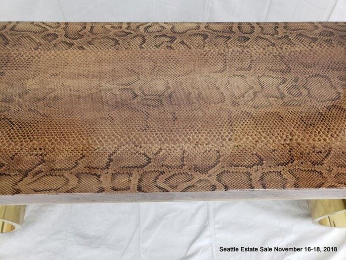 KARL SPRINGER Console table with python-covered top on polished brass base. 24" x 60" x 16"