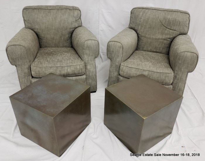 Upholstered club chair.
Patinated bronze cube-form side table.
