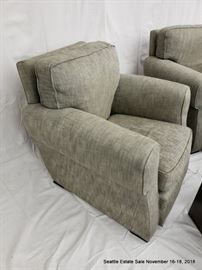 Upholstered club chair.
Patinated bronze cube-form side table.