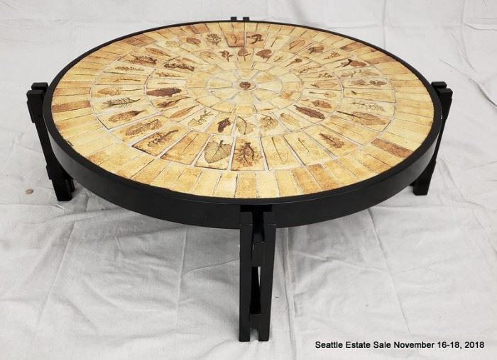 Pressed-leaf mosaic coffee table with ebonized base.