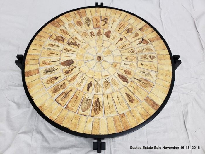 Pressed-leaf mosaic coffee table with ebonized base.