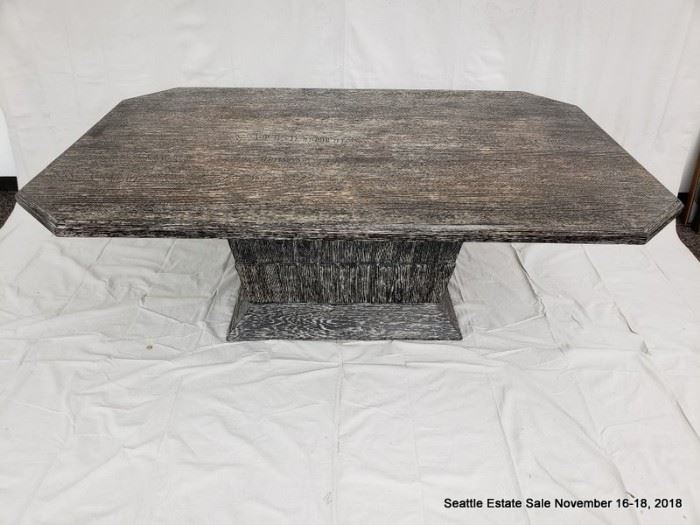 Rectangular cut-corner pedestal table with black and white striated cerused wood finish.