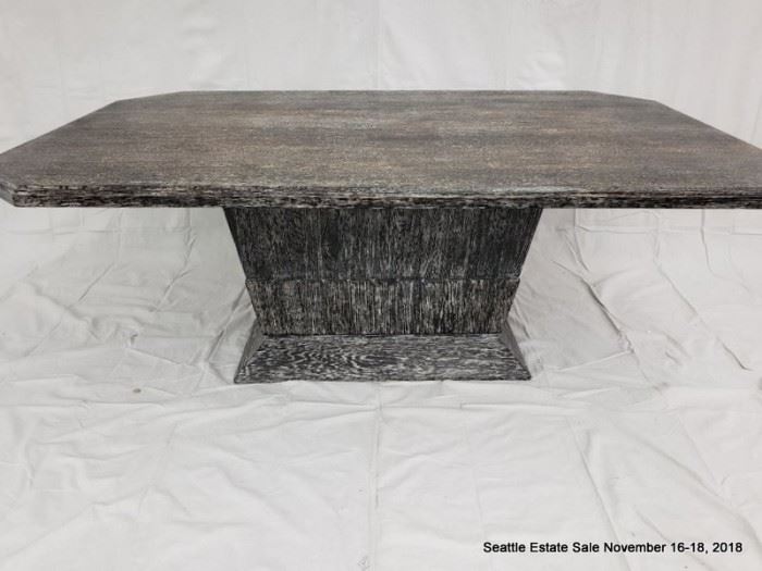 Rectangular cut-corner pedestal table with black and white striated cerused wood finish.