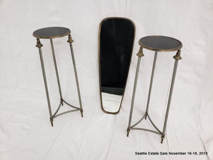 Patinated bronze and glass pedestal table with fluted accents. Kelly Wearstler Maverick Mirror bronze-framed wall mirror.