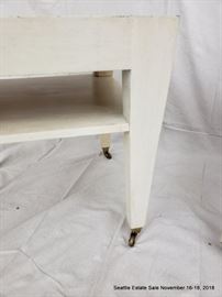 Square-form side table with bronze casters.