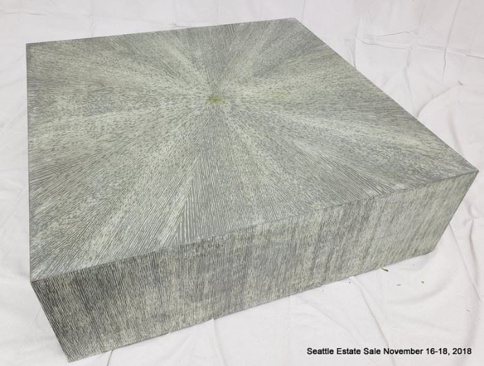 Square flush-side coffee table with green-tone striated cerused wood finish.