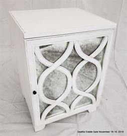 Mirrored-front single door cabinet with white finish.