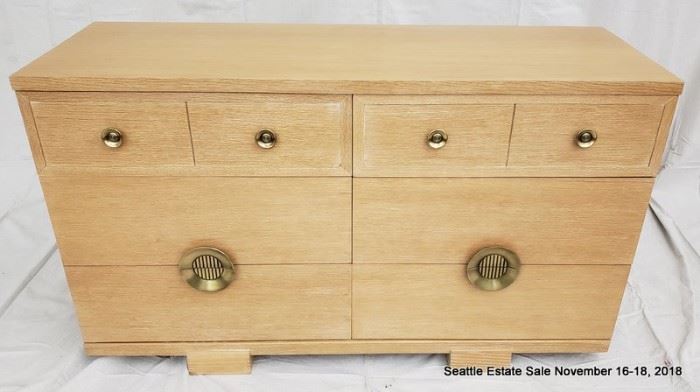 Blonde wood and brass handled dresser.