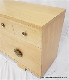 Blonde wood and brass handled dresser.