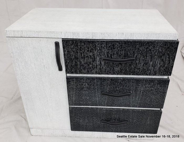 Black and white three drawer cerused wood dresser with leather handles.