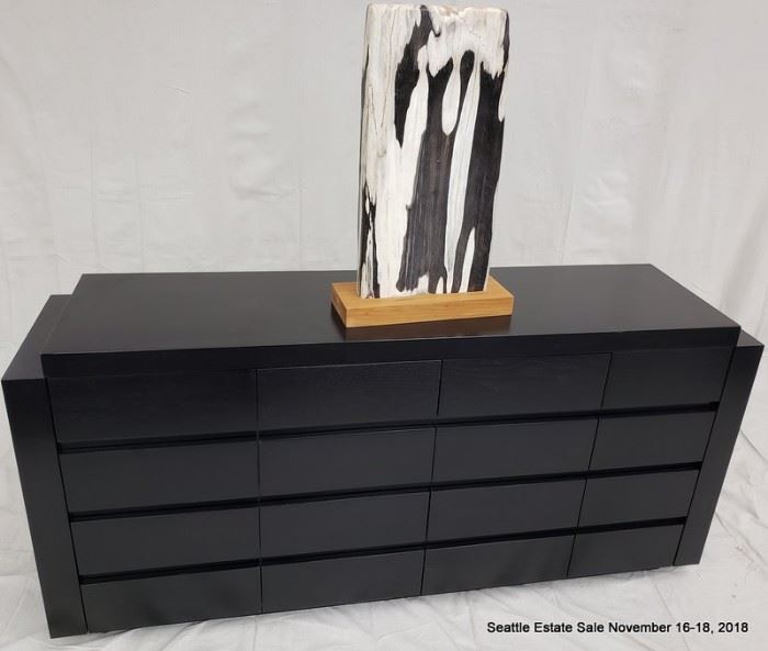 16-Drawer credenza with textured ebonized cerused wood finish.
Black and white striated stone accent sculpture.