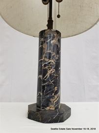 Table lamp with octagonal marble standard and white shade.
