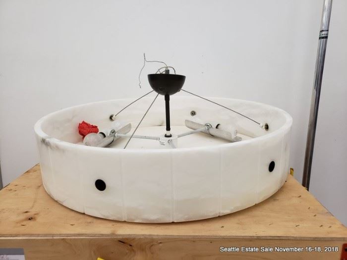 Large round contemporary stone look ceiling fixture with black accents.