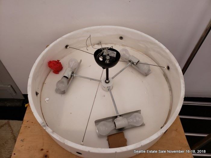 Large round contemporary stone look ceiling fixture with black accents.