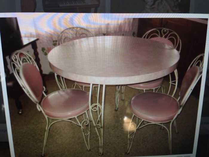 Darling pink formica 1950's table with one leaf, iron chairs with original pink naugahyde. A hard to find set