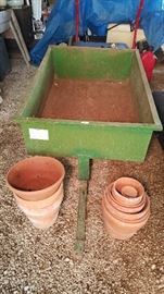 Voss Bros presents this 48x33" small gardening trailer. Great for your 4 wheeler or tractor. This trailer will need new tires. This lot comes complete with several terracotta pots.