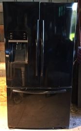 Black side-by-side Samsung refrigerator with lower drawer freezer.  Owner States the refrigerator is in working condition. It will need cleaned. Model Number RFG298HDBP.