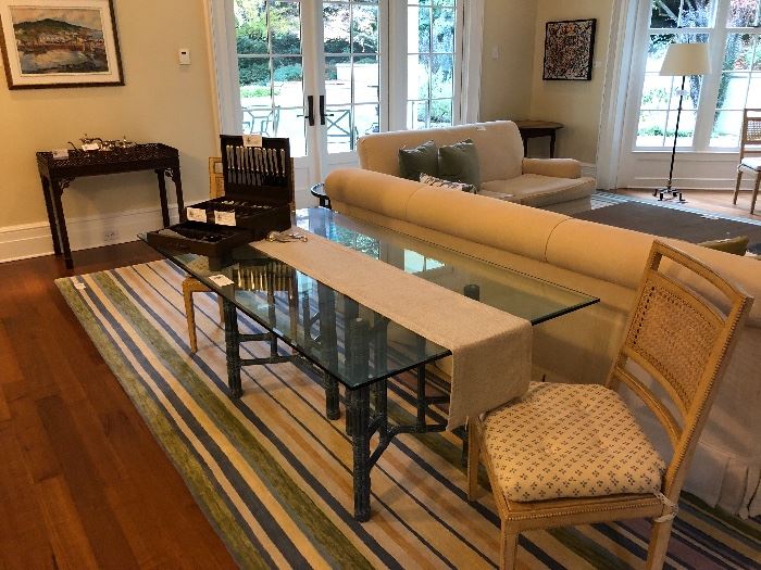 McGuire glass top table and two of the four chairs available