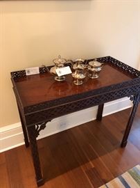 One of two Chippendale tables (sold as a pair) and a silver plate tea set. 