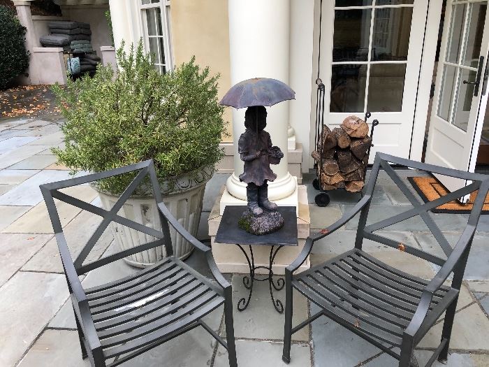 Resin and metal sculpture shown on top of metal side table and two of the ten Restoration Hardware dining chairs