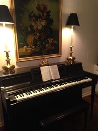 Wurlitzer piano; candlestick lamps with black shades